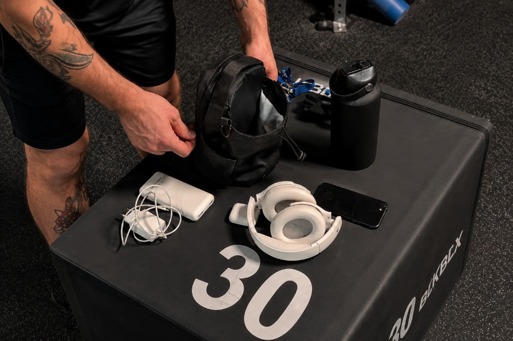 Gym bag and essentials organized on a plyo box